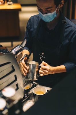 A barista preparing coffee with a smile.