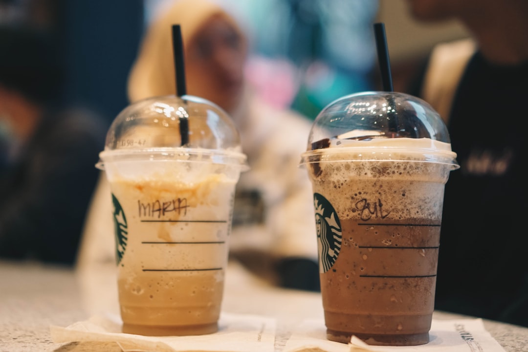 clear plastic cup with brown liquid