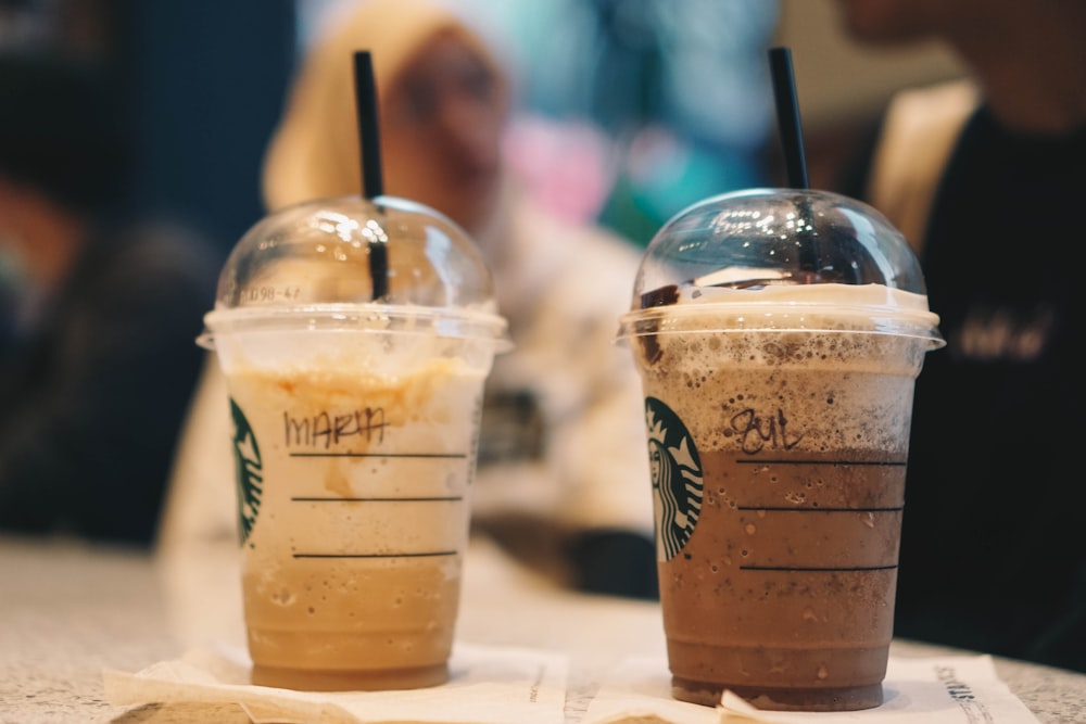 clear plastic cup with brown liquid