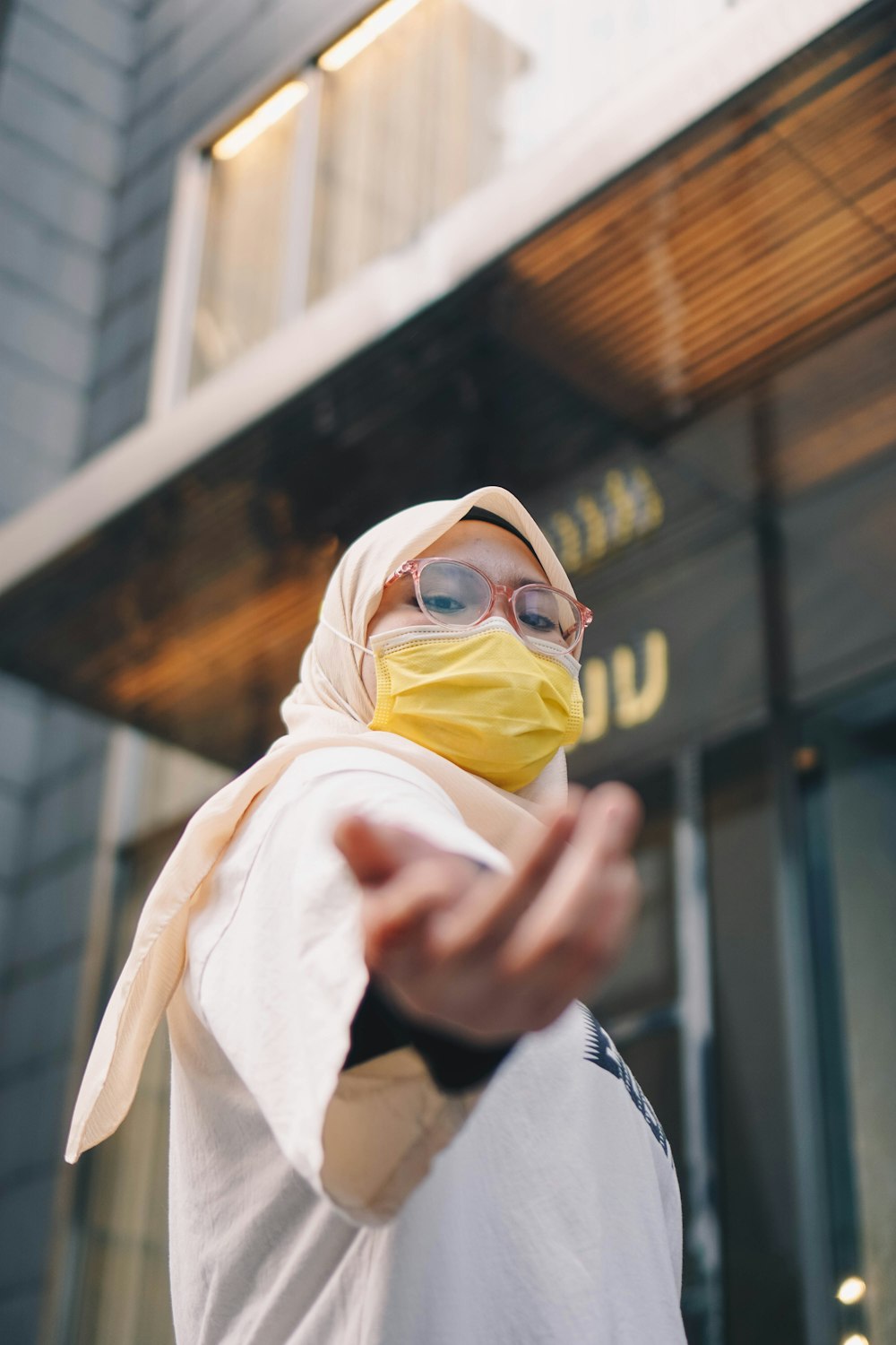 person in white hijab and black framed eyeglasses