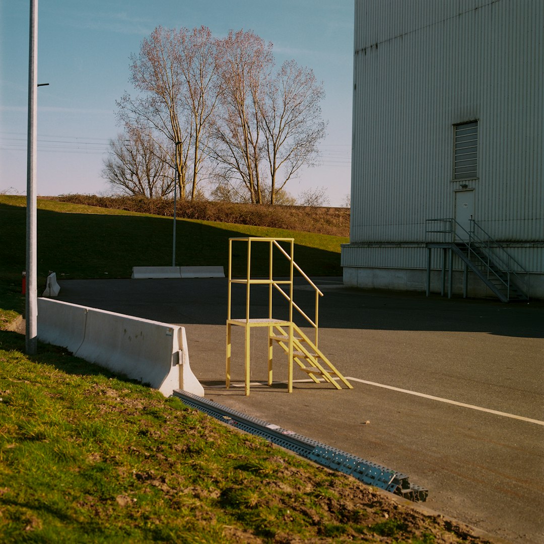 white metal post near white building during daytime