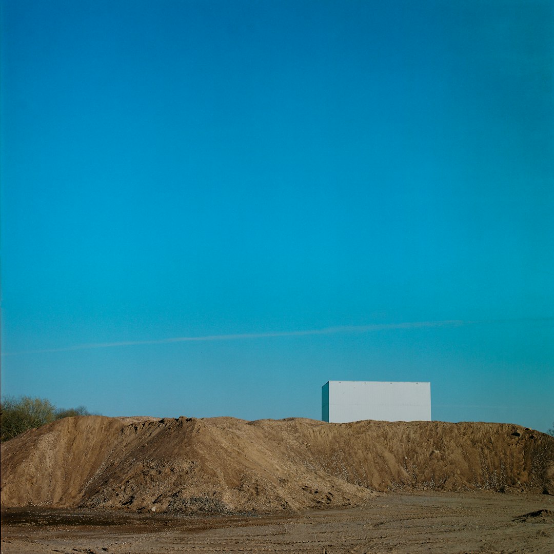 white box on brown field under blue sky during daytime