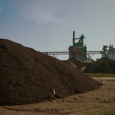 green metal machine on brown hill under white clouds during daytime