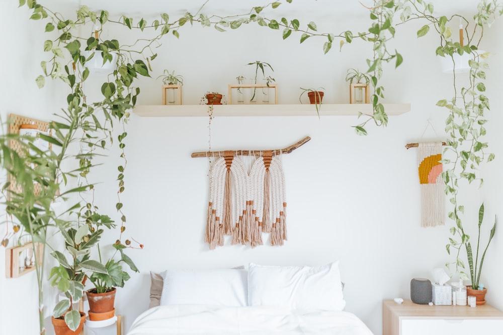 white and brown floral textile on white bed