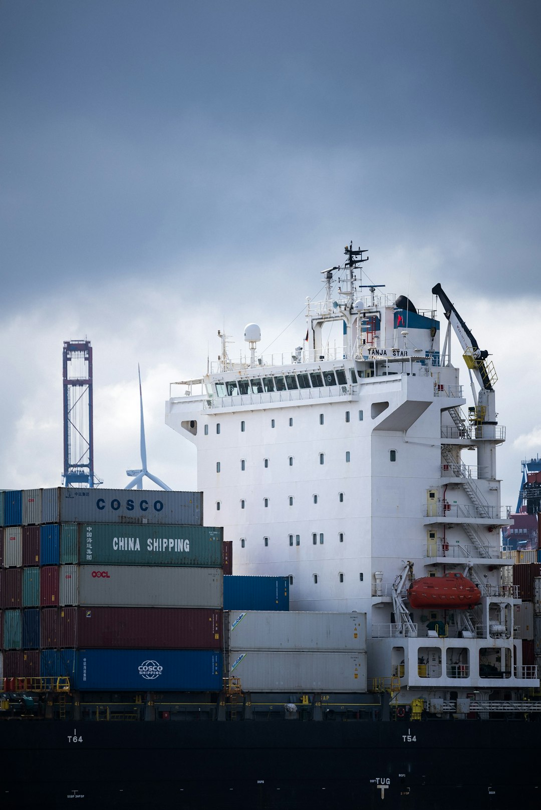 white and blue cargo ship on dock during daytime