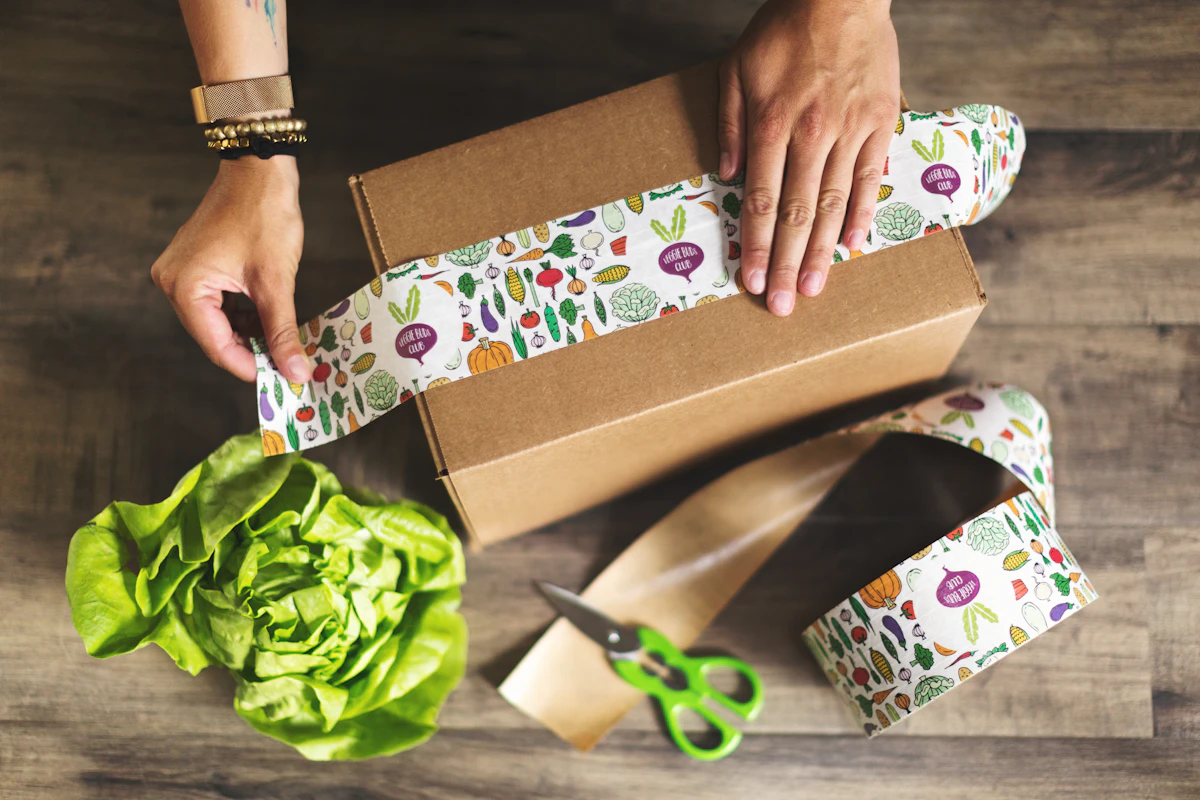 Hands preparing and packing a cardboard box