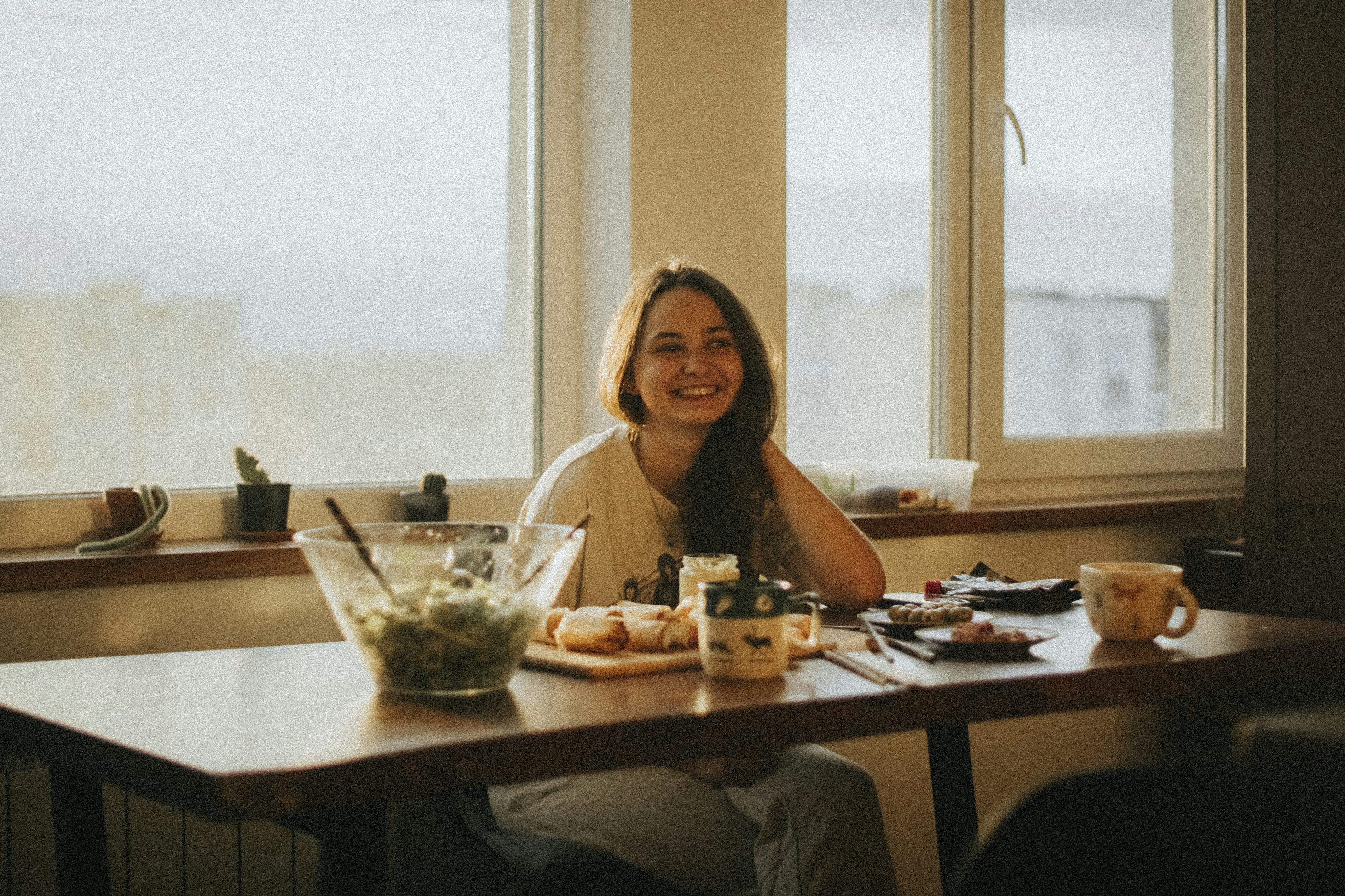 woman in black tank top sitting on chair in front of table