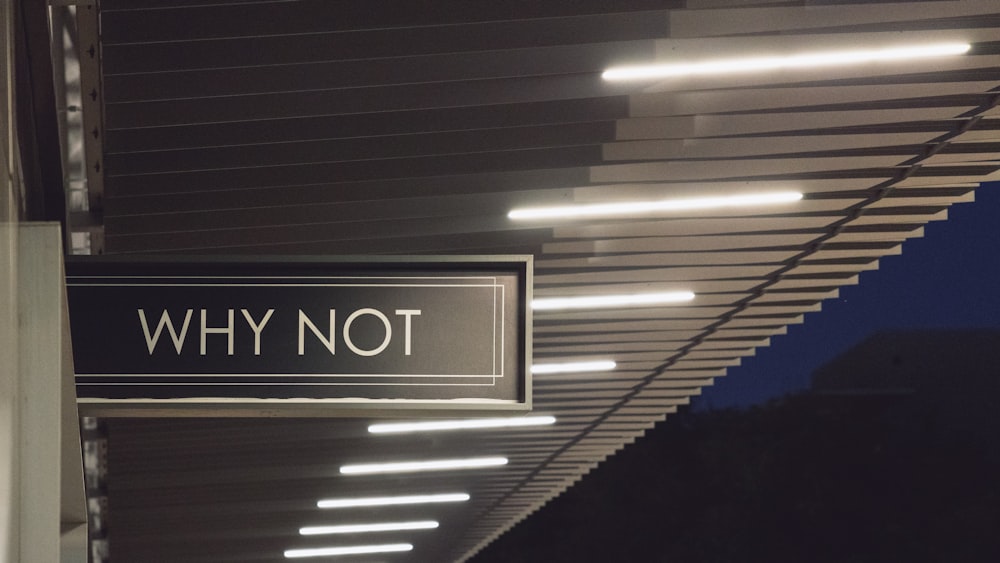 a black and white sign hanging from the side of a building