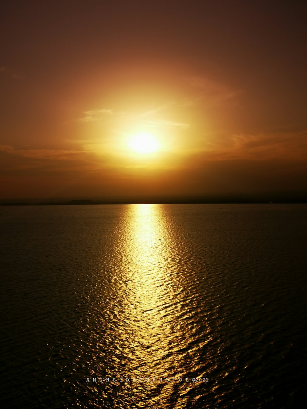 calm sea under orange sky during sunset