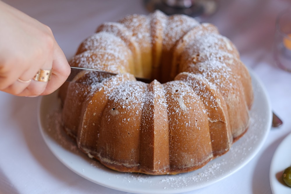 brown doughnut on white ceramic plate