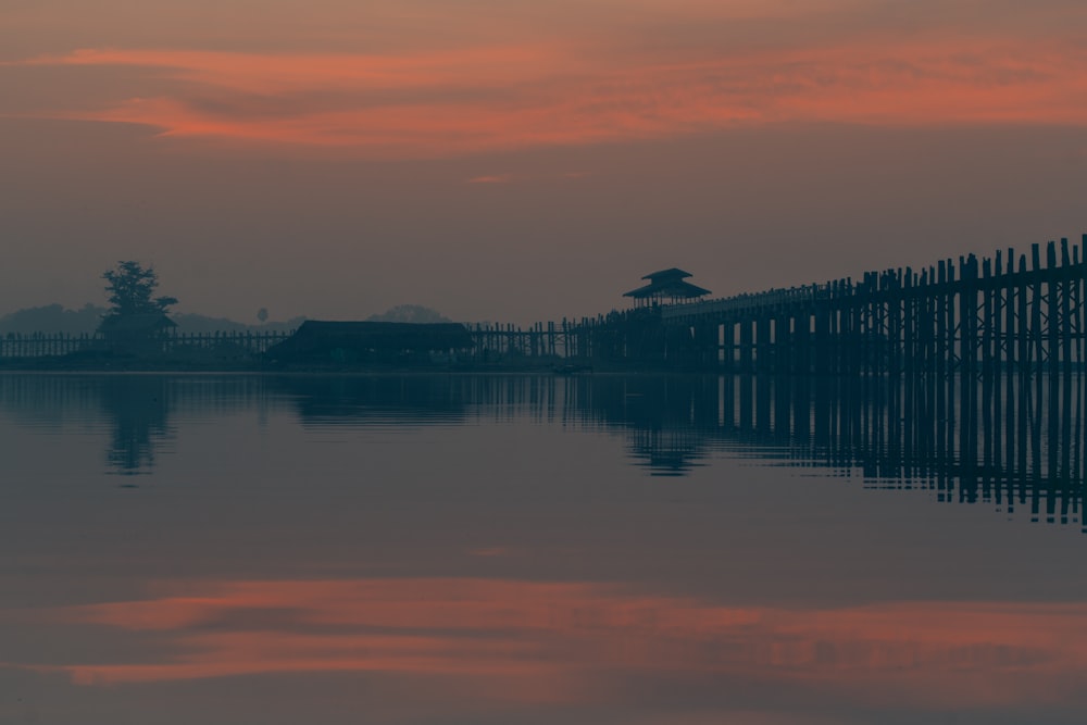 body of water near bridge under blue sky during daytime