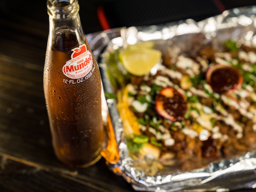 coca cola glass bottle beside vegetable salad