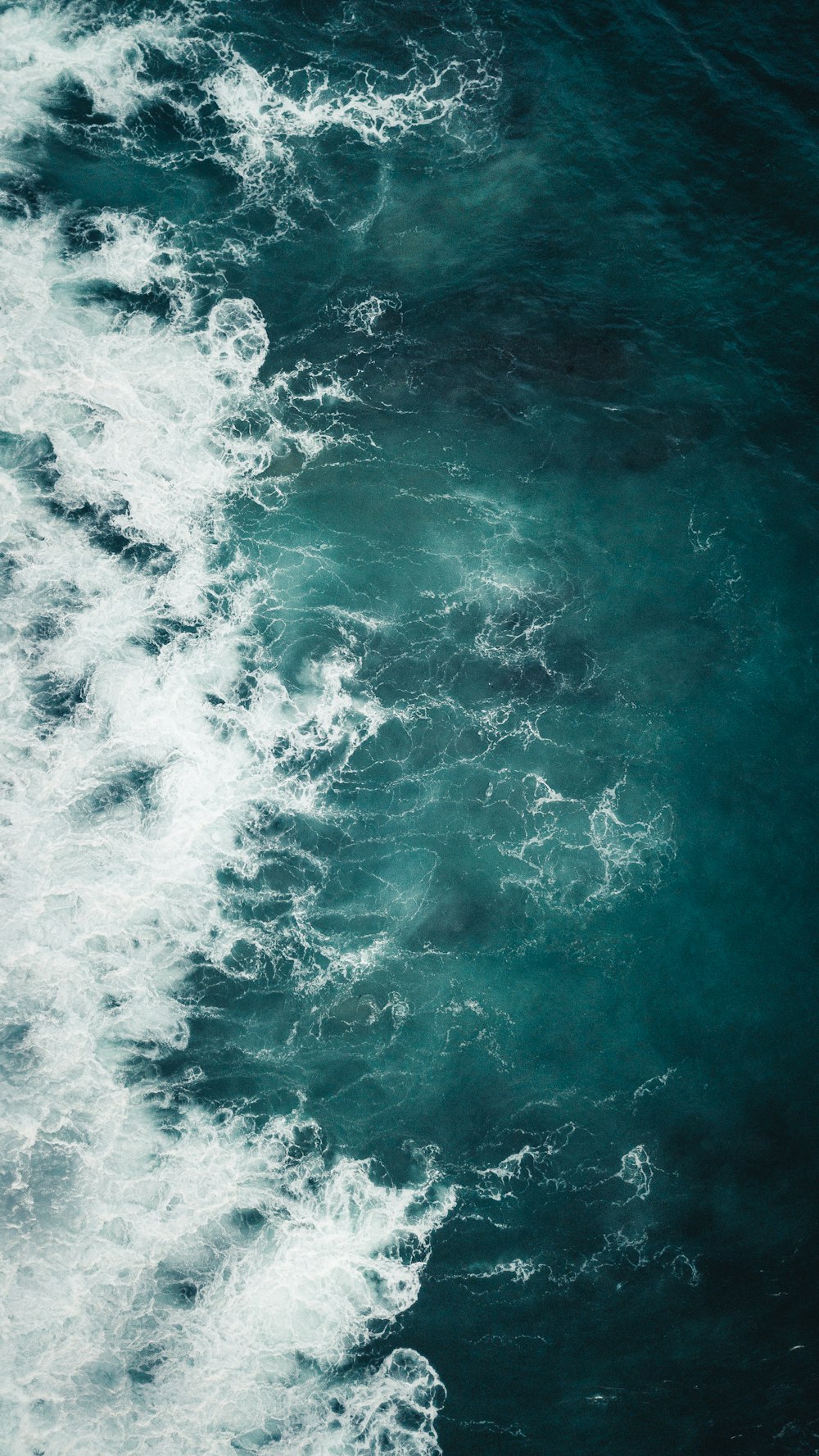 ocean waves crashing on shore during daytime