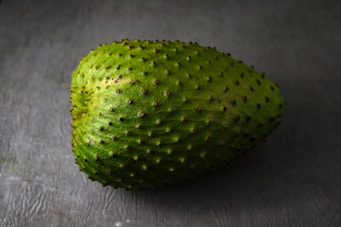green round fruit on gray textile