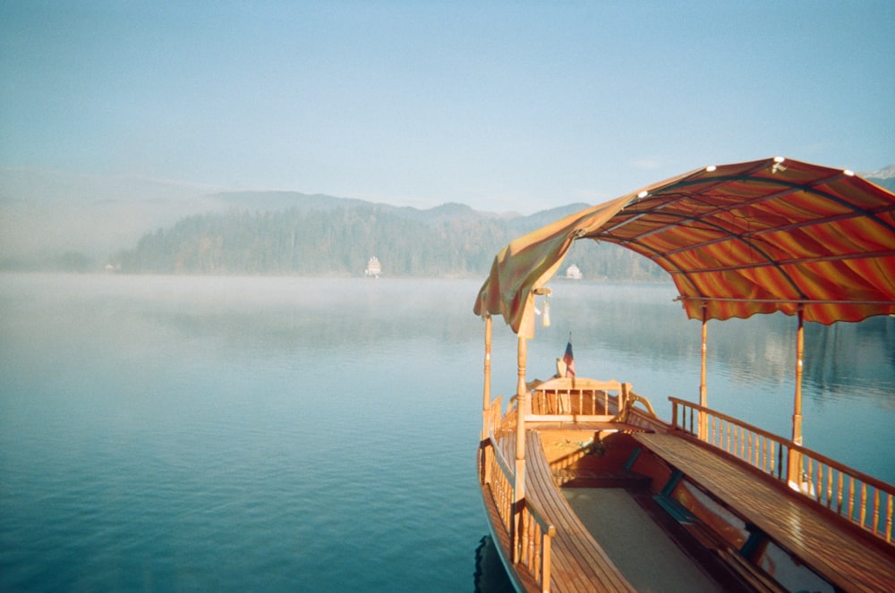 brown wooden boat on body of water during daytime