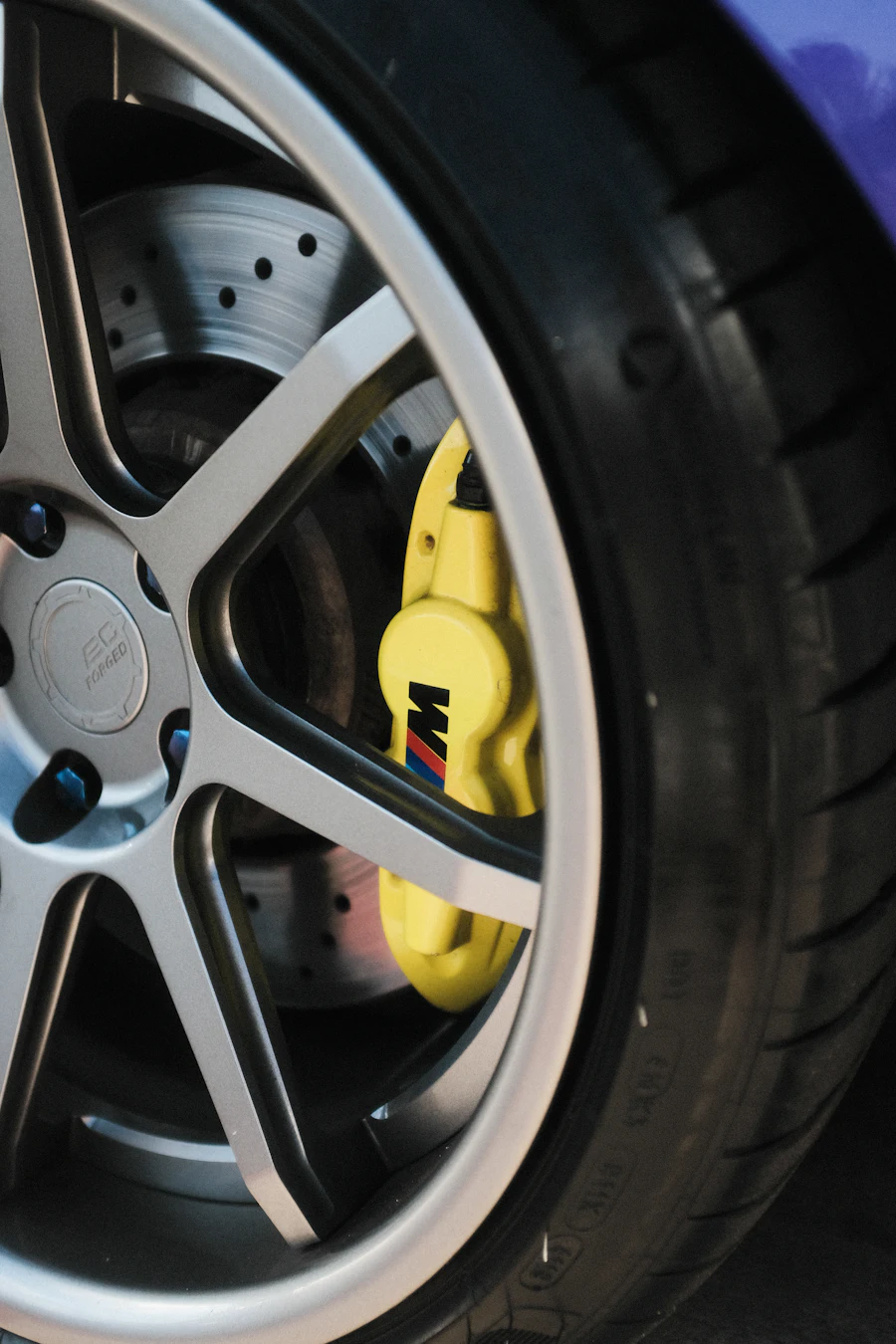 Bright brake caliper behind a wheel after a mobile brake repair
