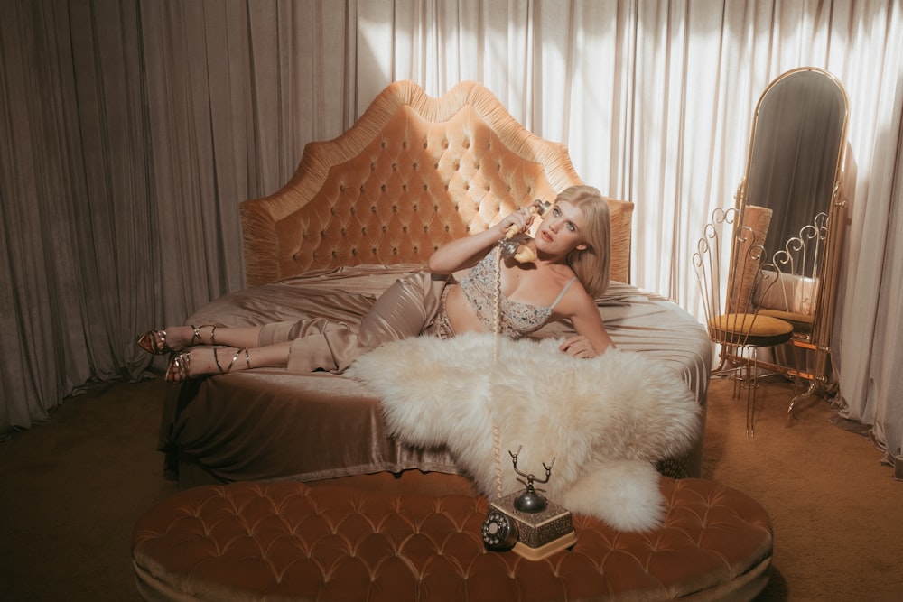 woman in white dress sitting on brown sofa chair