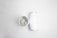 A pair of aluminum cans are placed on a plain white background. One can is viewed from the top, showcasing the pull-tab, while the other is lying on its side, displaying its cylindrical shape.