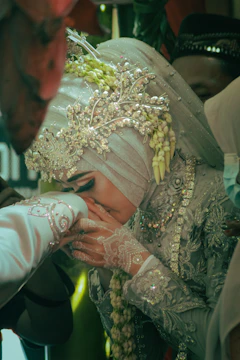 Close-up of hands exchanging respectful bows in formal attire.