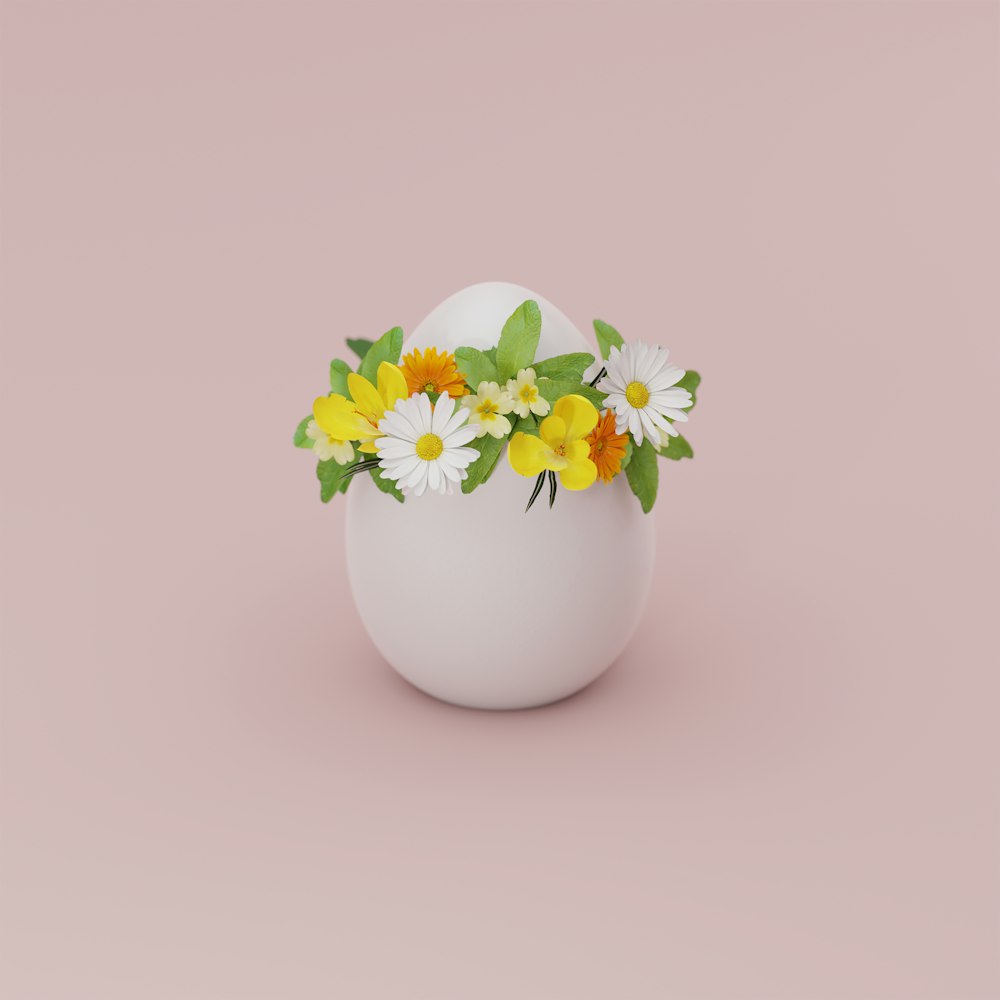 white and yellow flower in white ceramic vase