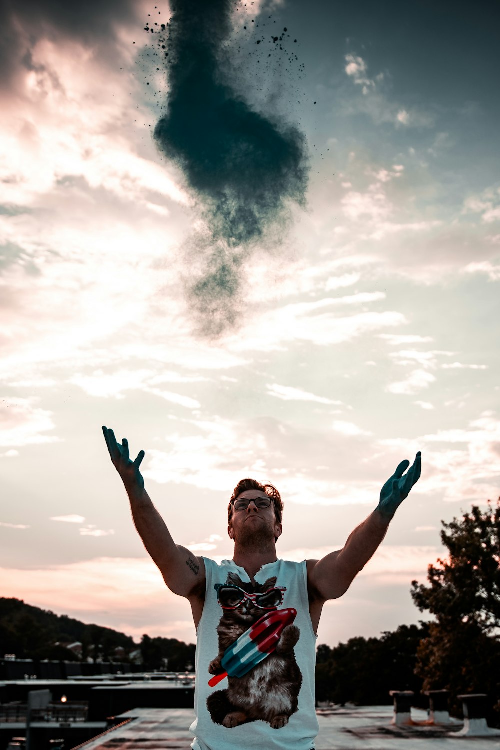 man in white polo shirt raising his hands under cloudy sky during daytime