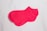 Two pink socks are neatly placed on a plain white surface. The socks have a simple design with no patterns or additional colors.