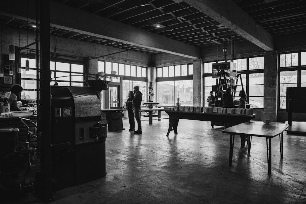 grayscale photo of people in a building