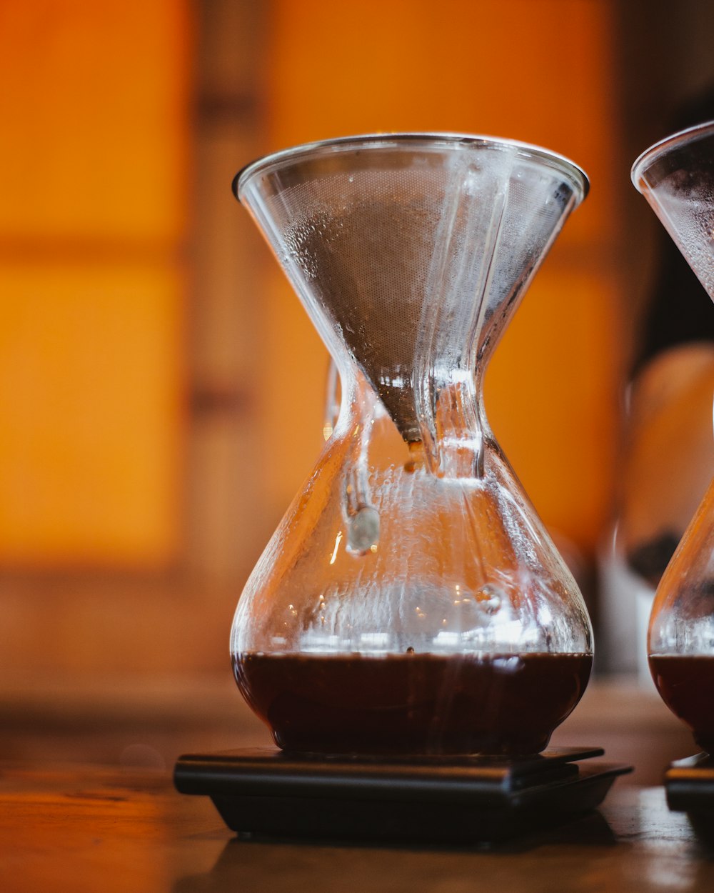 clear glass hour glass on brown wooden table