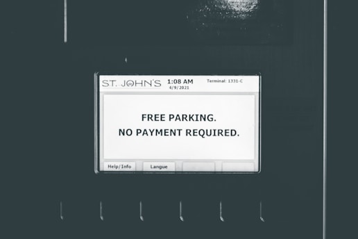 A screen displays a message indicating free parking with no payment required. The screen is labeled with 'ST. JOHN'S' at the top and shows a timestamp of '1:08 AM 4/9/2021' and 'Terminal: 1331-C'. There are buttons for 'Help/Info' and 'Langue' at the bottom of the screen.