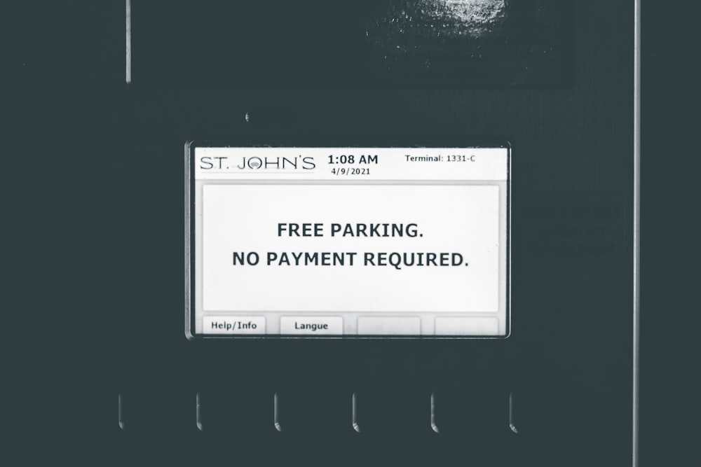 a black and white photo of a parking sign