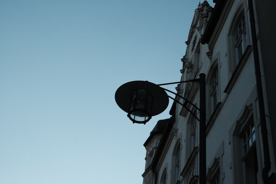 black street light on gray concrete building during daytime