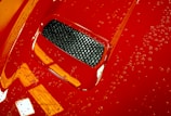 Close-up of a shiny, freshly cleaned car chassis with water droplets reflecting light.