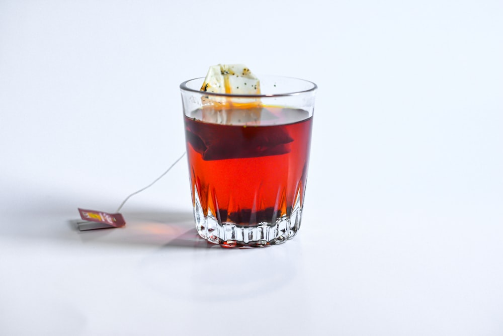 clear drinking glass with red liquid