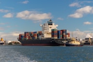 cargo ship on sea under blue sky during daytime