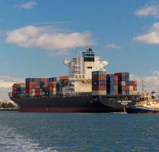 cargo ship on sea under blue sky during daytime