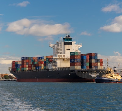 cargo ship on sea under blue sky during daytime