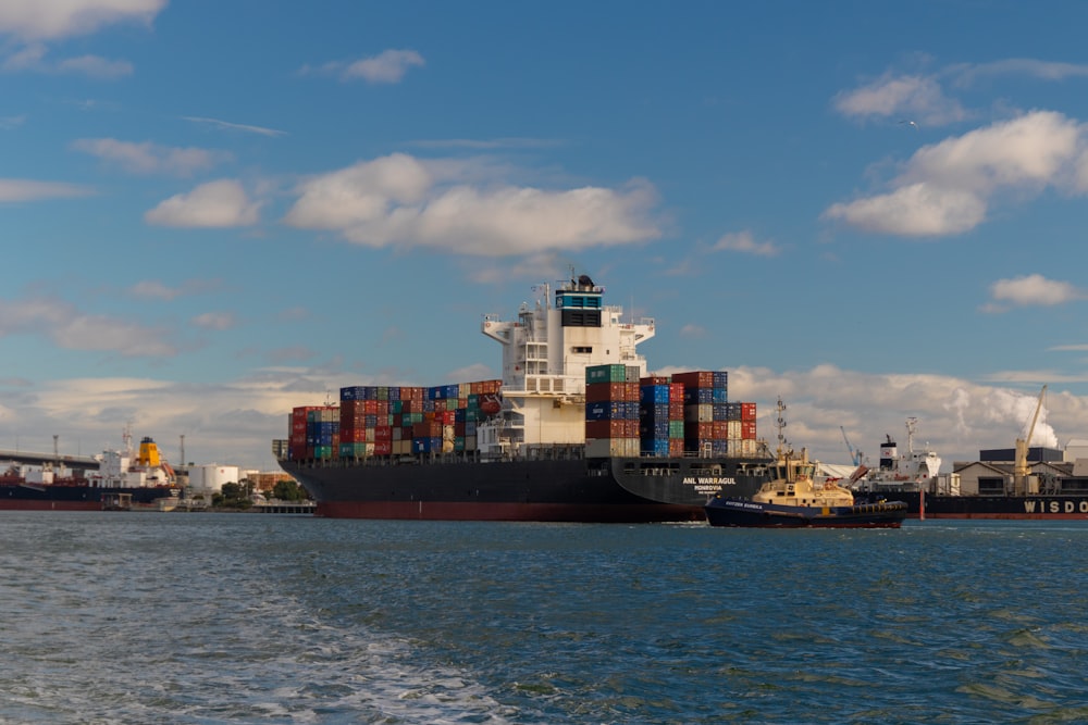 cargo ship on sea under blue sky during daytime