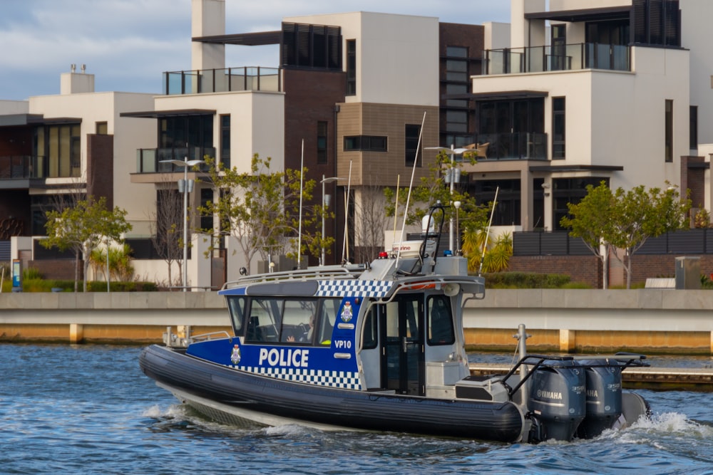 blue and white boat on water during daytime