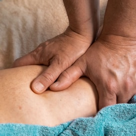 persons feet on blue towel