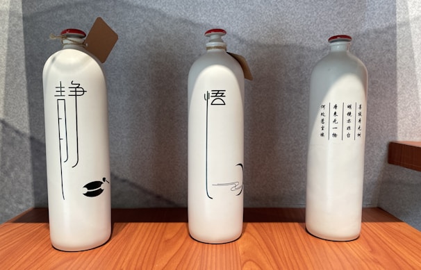 Close-up of traditional Chinese baijiu bottles displayed with elegant calligraphy labels