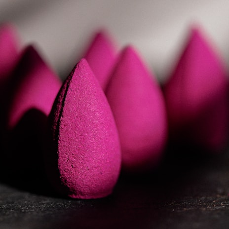 A close-up of a beautifully designed makeup sponge set in various colors.