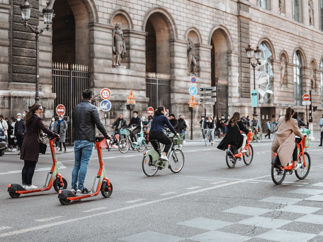 people riding bicycles on road during daytime