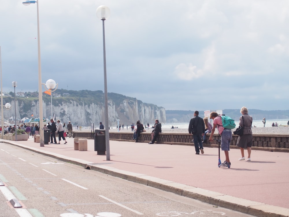 people walking on gray concrete road during daytime