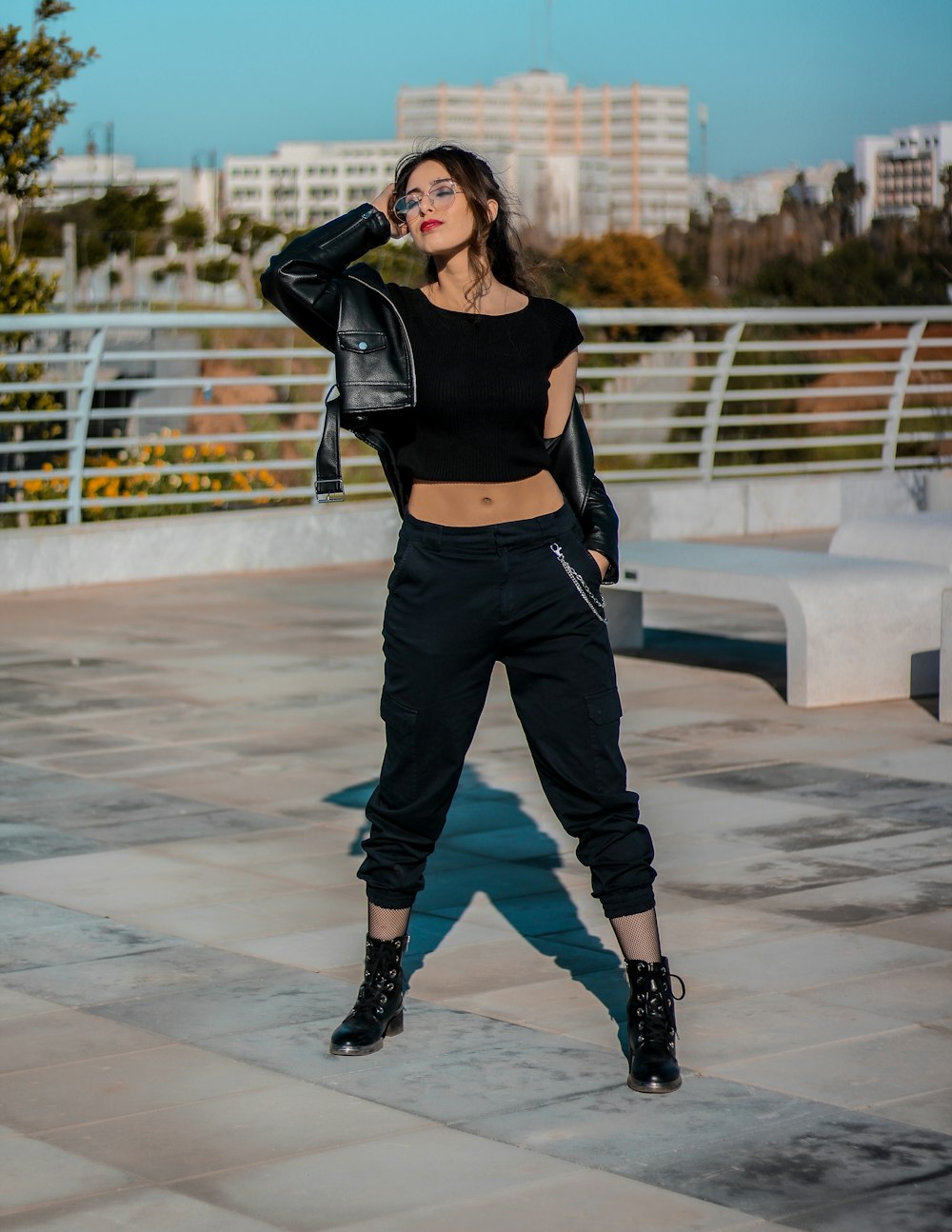 woman in black sports bra and black pants standing on white floor