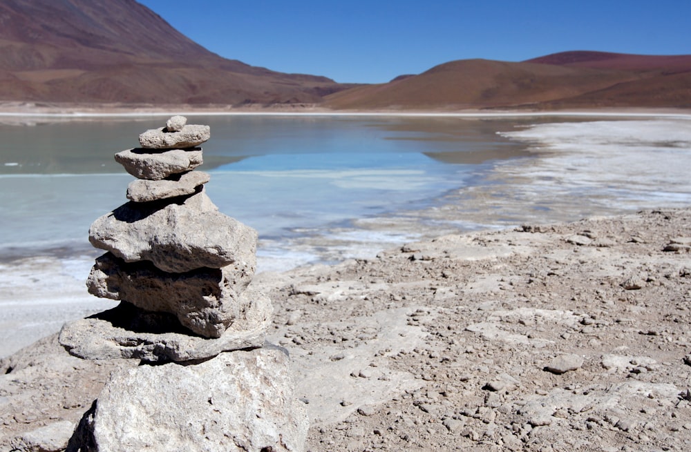 brown rock formation near body of water during daytime