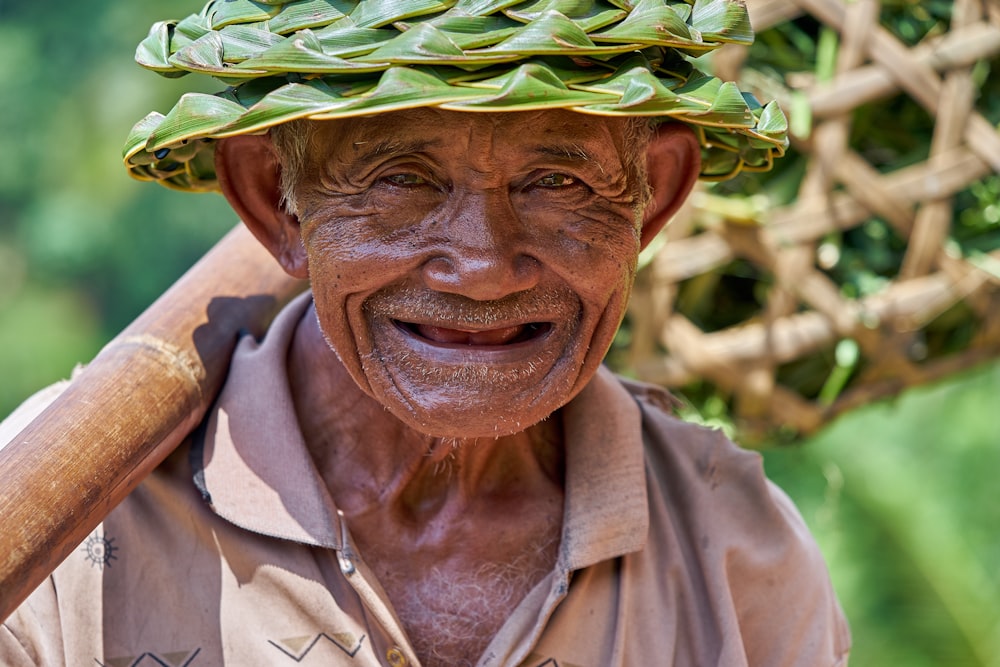 man in brown button up shirt wearing green hat