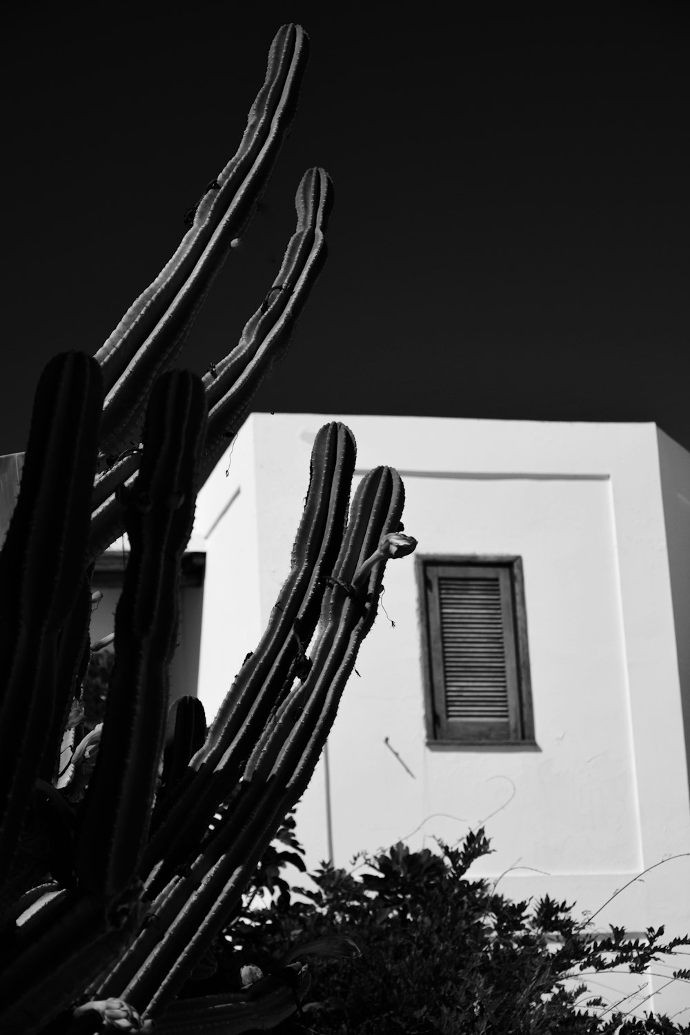 white window type air conditioner on white wall