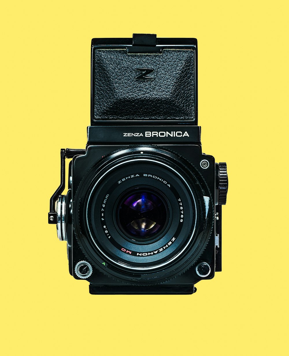 black nikon dslr camera on yellow background