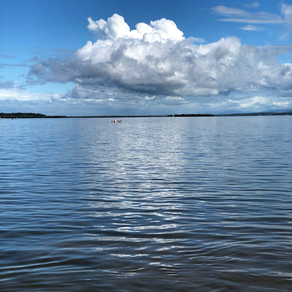 blue sea under white clouds and blue sky during daytime