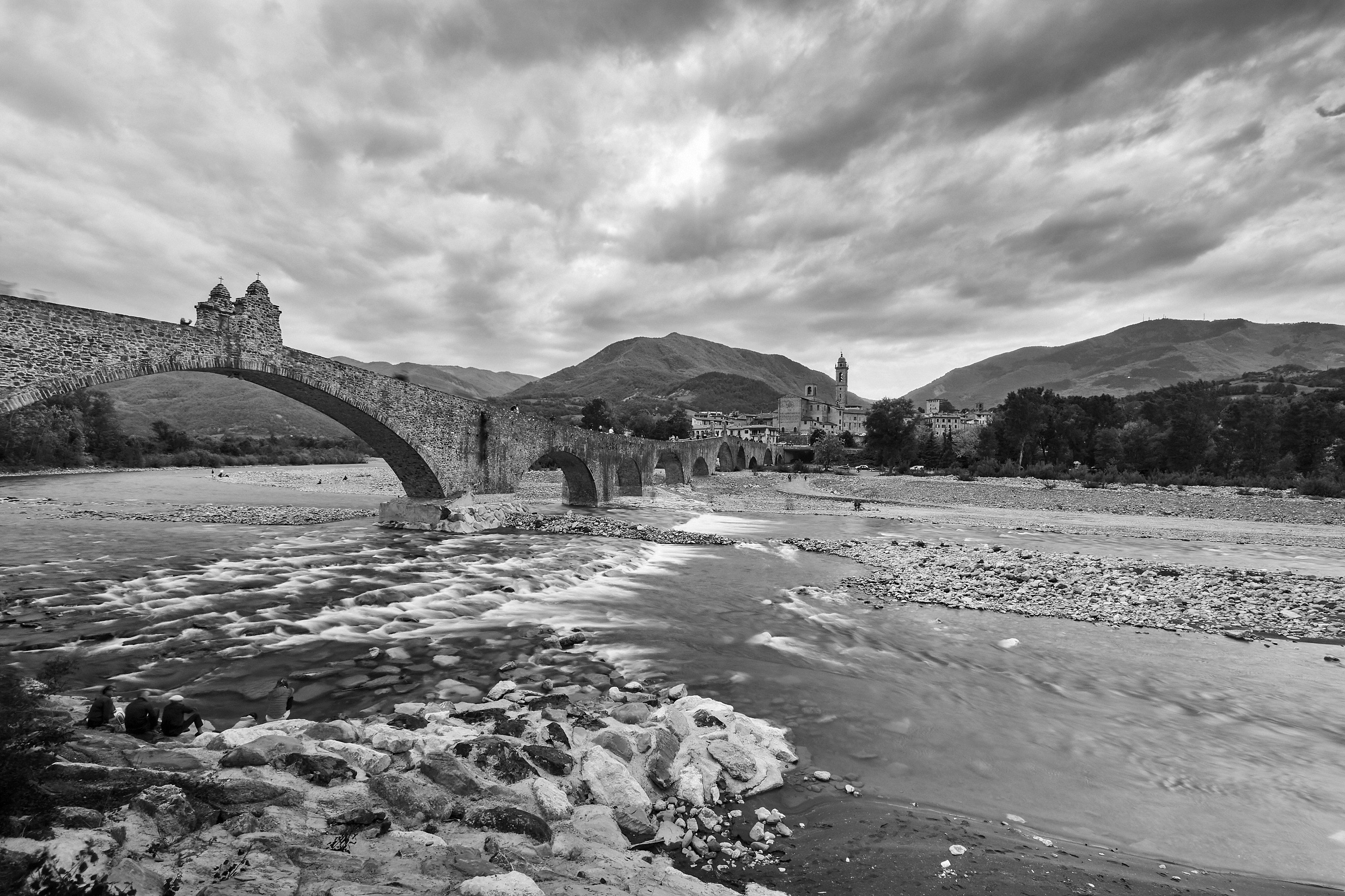 grayscale photo of bridge over river
